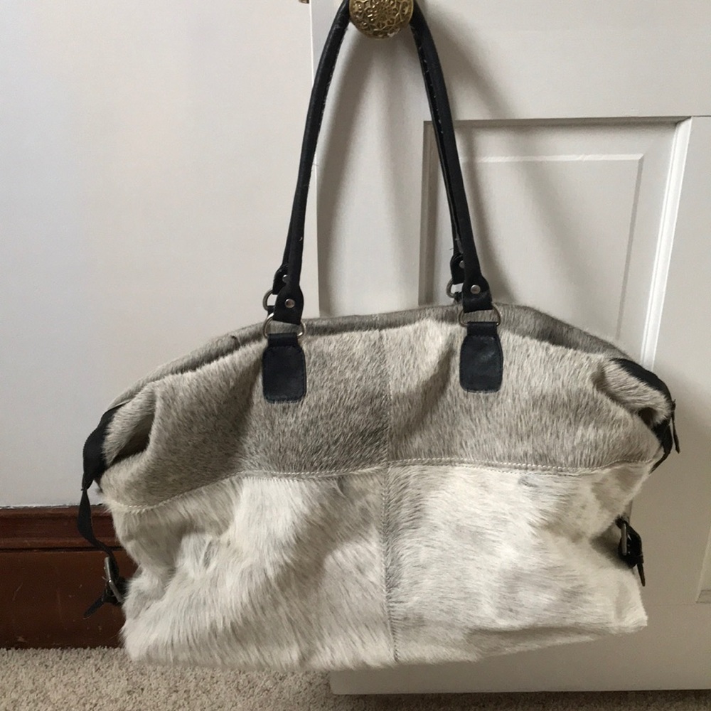 An animal hide overnight bag (cow?)